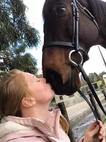 Woman kissing a horse